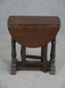 A mid century oak Jacobean style drop flap occasional table. H.51 W.62 D.47cm. (ext).