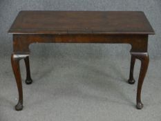 A Georgian mahogany side table or centre table with crossbanded top raised on cabriole supports,