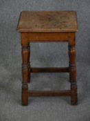 A 19th century oak stool on turned stretchered supports. H.60 W.38 D.28cm.