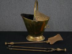 A 19th century brass coal helmet along with brass shovel and tongs. H.52 W.37 D.30cm.