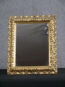 A continental 19th century style wall mirror in carved giltwood frame. H.53 W.42cm.
