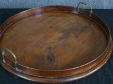 A Georgian mahogany brass twin handled tray. Dia.47cm.