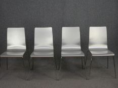 A set of four vintage lacquered laminated ply side chairs on chrome supports.