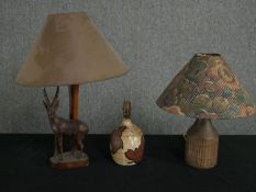 Two vintage glazed ceramic table lamps and another with a carved gazelle base. H.48cm (largest).