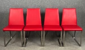 A set of four dining chairs in faux leather on chrome supports. H.84 W.43 D.42cm.