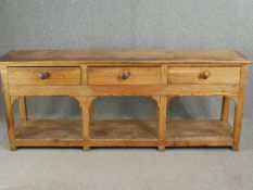 A 19th century pitch pine dresser base with pot board under raised on block supports. H.81 W.210 D.