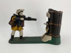 A painted cast iron William Tell money bank. H.17 W.26cm