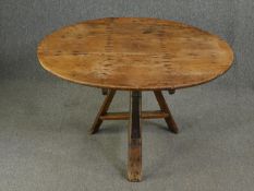 A 19th century Dutch pine tilt top table. H.62 Dia.99cm.