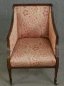 An Edwardian mahogany tub armchair. H.85cm.