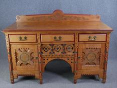 A late 19th century light oak Aesthetic style sideboard with carved and painted detail. H.120 W.
