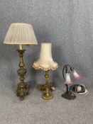 A mid century carved giltwood ecclesiastic style table lamp, a gilt metal similar and a twin