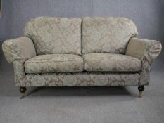 Sofa, contemporary Victorian style on mahogany turned supports terminating in brass cup casters. H.