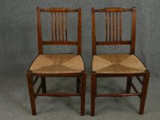 A pair of Georgian fruitwood rush seated dining chairs. H.100cm.