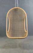 A vintage styled contemporary rattan hanging chair. H.110 W.68 D.58cm