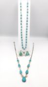 A collection of turquoise and silver jewellery to include a pair of earrings and two necklaces,