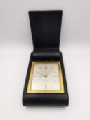 A brass Jaeger Le Coultre 8 Swiss made leather bound travel clock. L.11 W.6.4 H.2.3cm (clock 6.2 x