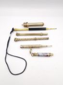 A collection of six gold metal propelling pencils, two showing makers marks W.S Hicks and Mable &