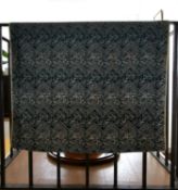 A blue linen backed textile wall hanging with embroidered Arabic text, possibly verses from the