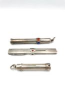 Three silver propelling coloured pencils with interchangeable black, blue and red options, one