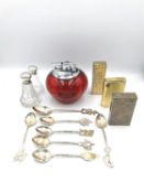 A mixed lot to include a set of six white metal spoons, a silvered shell, glass salts with silver