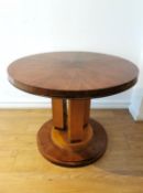 An Art Deco kingwood and satinwood centre table raised on a pedestal base. H.66 dia. 64cm