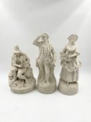 A pair of bisque figures and a similar figure. H.36cm (largest)