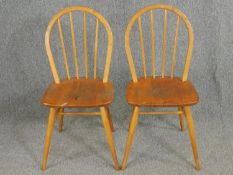 A pair of Ercol model 400 beech and elm stick back chairs.