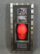 A signed Lewis Hamilton Vodafone cap, cased with race photographs along with a certificate of