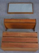A mid century teak suite of wall hanging furniture, viz: Mirror, console table and chest of