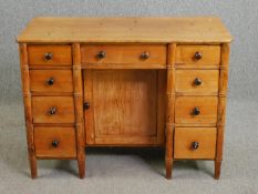 A 19th century faux bamboo design pine kneehole desk. H.79 W.107 D.51cm.