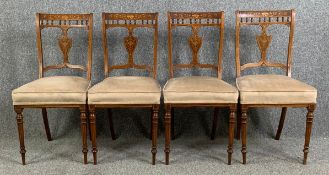 A set of four Edwardian rosewood and satinwood inlaid dining chairs reupholstered in piped velour.