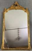 A large 19th century pier mirror with scrolling Rococo gesso cresting in a giltwood frame. H.222 W.