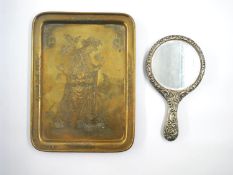 An early 20th century etched brass tray with goddess design and a repousse silver plated hand
