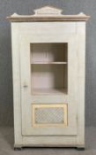 A 19th century French provincial hand painted pantry cupboard with panelled grille door enclosing
