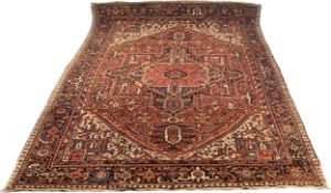 A large Hamadan carpet with central pole medallion on a burgundy ground within stylised foliate
