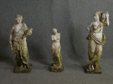 A pair of weathered composite stone classical style garden figures along with a smaller figure of