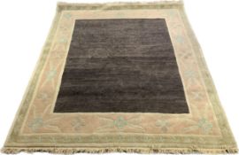 A Nepalese hand woven wool carpet with naturalistic foliate borders. L.322 W.250cm