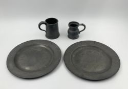 Four 18th/19th century items of pewter, two plates, a tankard and a measure. Dia.25cm (largest)
