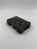 An Indian white metal box with filigree decoration and inset with semi precious stones. H.4 W.13 D.