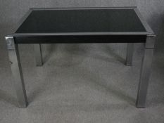 A 1970's plate glass and chrome extending dining table. Arch. La Metal Arredo, Paderno di Milano.