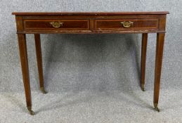 An Edwardian mahogany and satinwood inlaid writing table with inset leather top. H.77 W.107 D.50cm