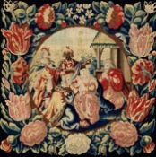 A framed tapestry panel depicting The Nativity with floral border. H.66 W.66cm