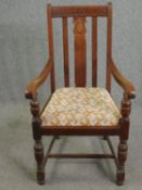 A mid century oak armchair in the antique style.
