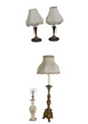 A pair of moulded bronzed table lamps, a mid century carved giltwood ecclesiastic style table lamp