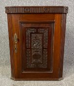 A 19th century carved walnut hanging corner cabinet. H.64 W.50 D.28cm