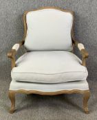 A contemporary French Provincial style beech framed armchair in piped calico upholstery. H.94 W.77
