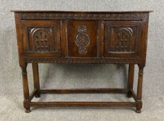 An 18th century carved oak side cabinet on turned and stretchered supports. H.85 W.106 D.34cm