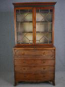 A Georgian mahogany library bookcase, in two sections fitted with a secretaire drawer. H.216 W.107