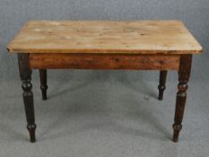 A 19th century pine kitchen table. H.74 W.132 D.79cm.