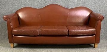 A serpentine back three seater sofa in tan leather upholstery raised on tapering block supports. H.